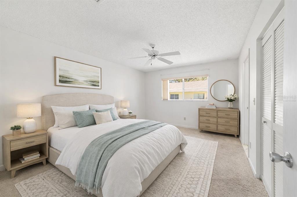 9460 Southwest 84th Terrace, Unit E Ocala, FL 34481 - Photo 12 of 21 a bedroom with a bed and a chandelier