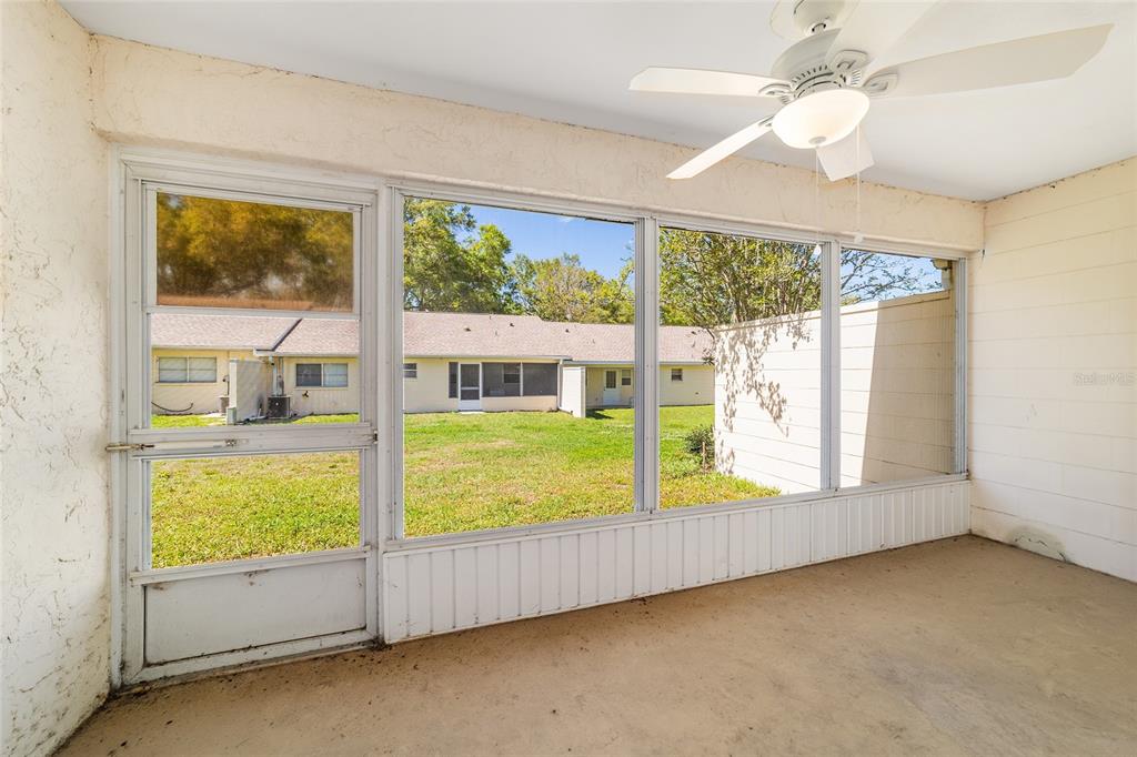 9460 Southwest 84th Terrace, Unit E Ocala, FL 34481 - Photo 20 of 21 wooden floor in an empty room with a window