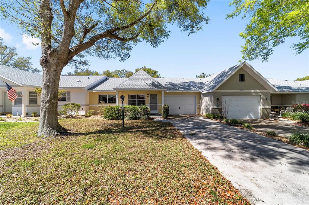 9460 Southwest 84th Terrace, Unit E Ocala, FL 34481 - Photo 2 of 21 a view of a house with backyard and sitting area