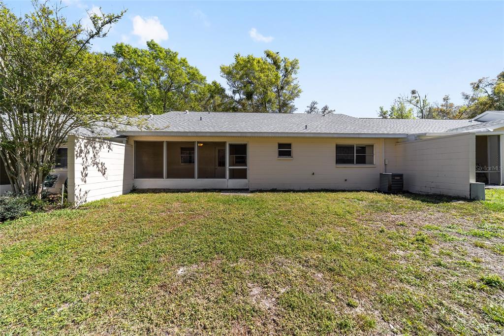 9460 Southwest 84th Terrace, Unit E Ocala, FL 34481 - Photo 21 of 21 a house with trees in the background
