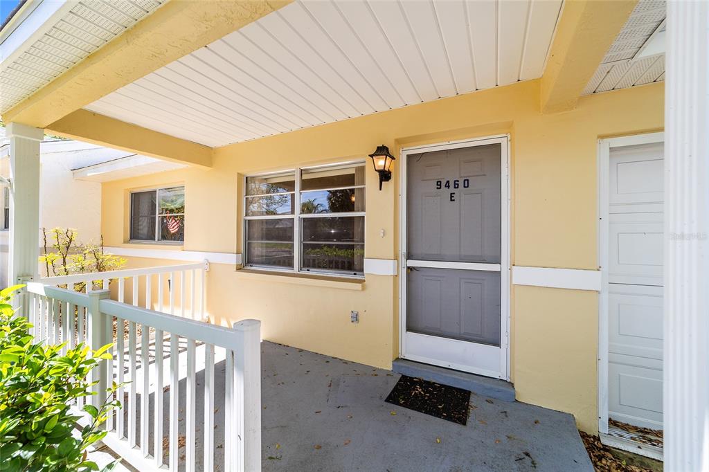 9460 Southwest 84th Terrace, Unit E Ocala, FL 34481 - Photo 3 of 21 a view of a porch with wooden floor and outdoor space