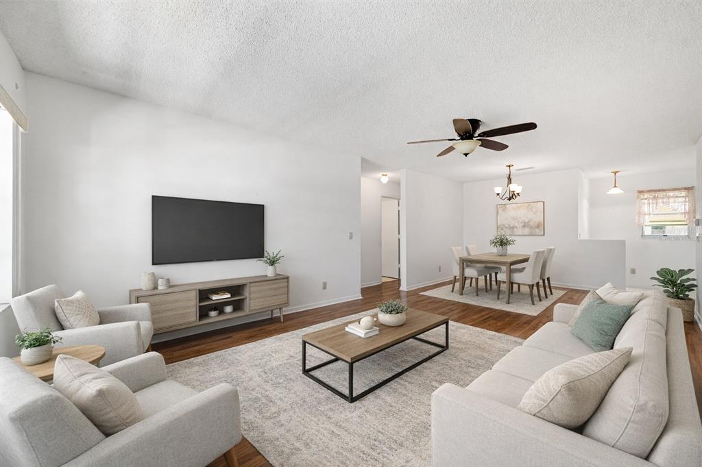 9460 Southwest 84th Terrace, Unit E Ocala, FL 34481 - Photo 4 of 21 a living room with furniture and a flat screen tv