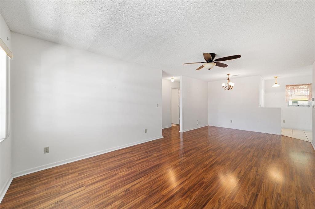 9460 Southwest 84th Terrace, Unit E Ocala, FL 34481 - Photo 5 of 21 wooden floor in an empty room