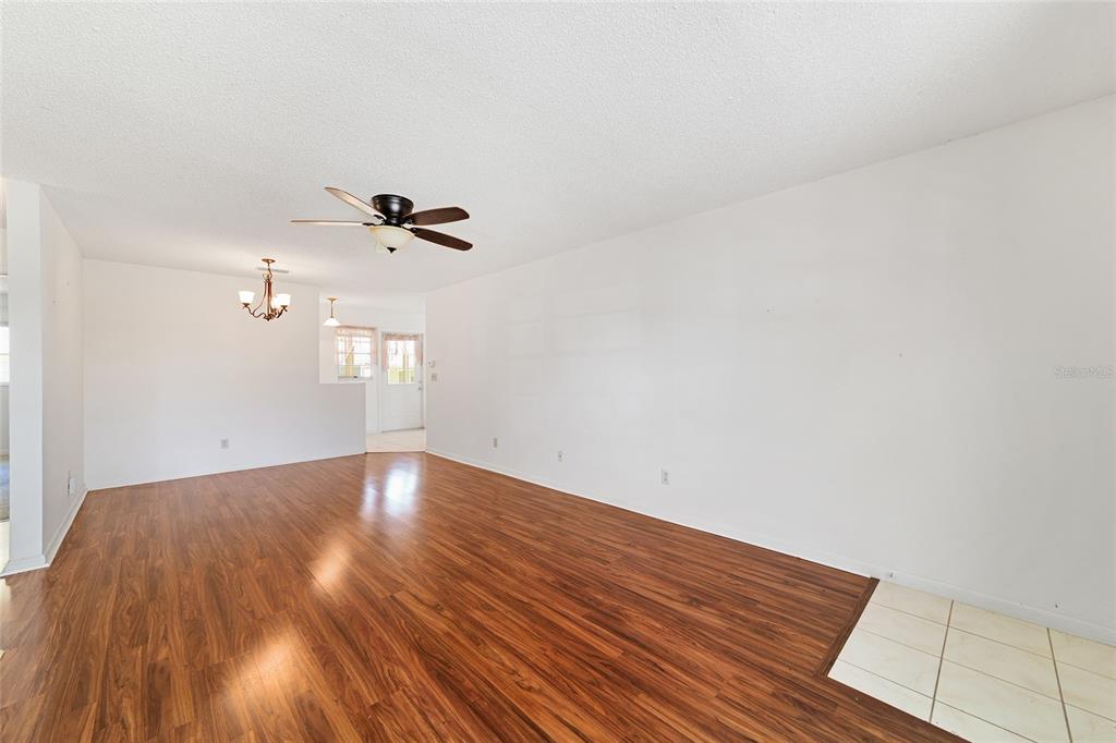 9460 Southwest 84th Terrace, Unit E Ocala, FL 34481 - Photo 6 of 21 a view of a room with wooden floor and white walls