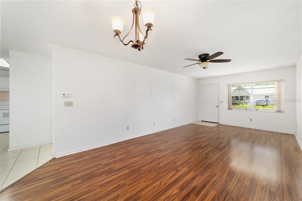 9460 Southwest 84th Terrace, Unit E Ocala, FL 34481 - Photo 7 of 21 wooden floor in an empty room