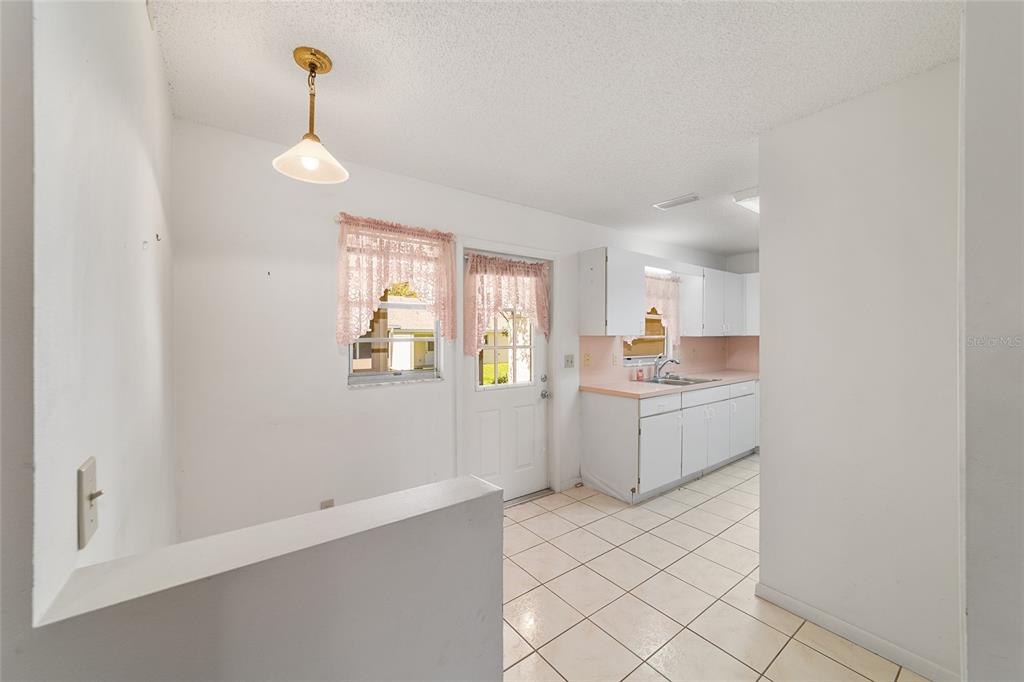 9460 Southwest 84th Terrace, Unit E Ocala, FL 34481 - Photo 8 of 21 a kitchen with a refrigerator and window