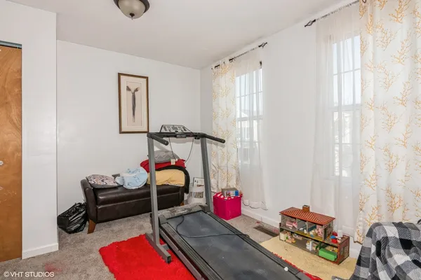 a living room with furniture a rug and a window