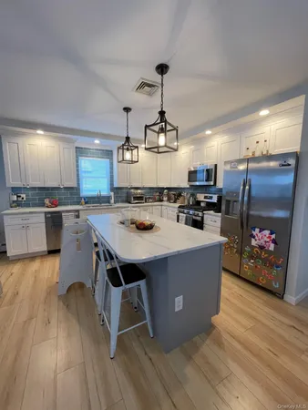 a kitchen with stainless steel appliances granite countertop a stove and a refrigerator