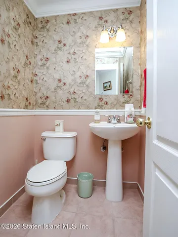 a bathroom with a sink a toilet and mirror