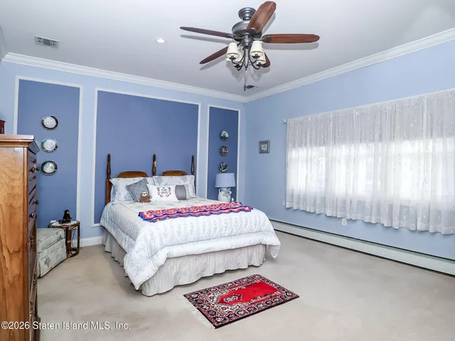 a spacious bedroom with a bed and a chandelier