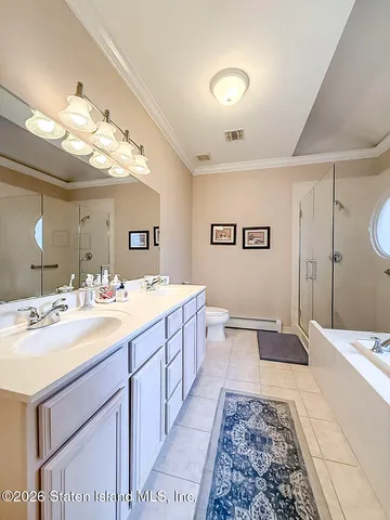 a spacious bathroom with a double vanity sink and a mirror