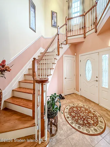 a view of staircase with wooden floor and a potted plant