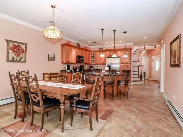 a view of a dining room with furniture and chandelier