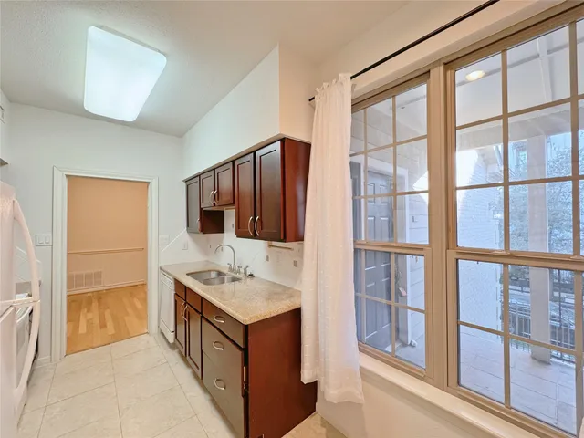 a bathroom with a granite countertop sink and a large mirror