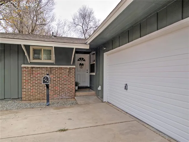 a view of a house with a door and wooden fence