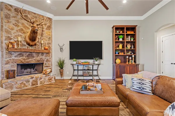 a living room with furniture a flat screen tv and a fireplace