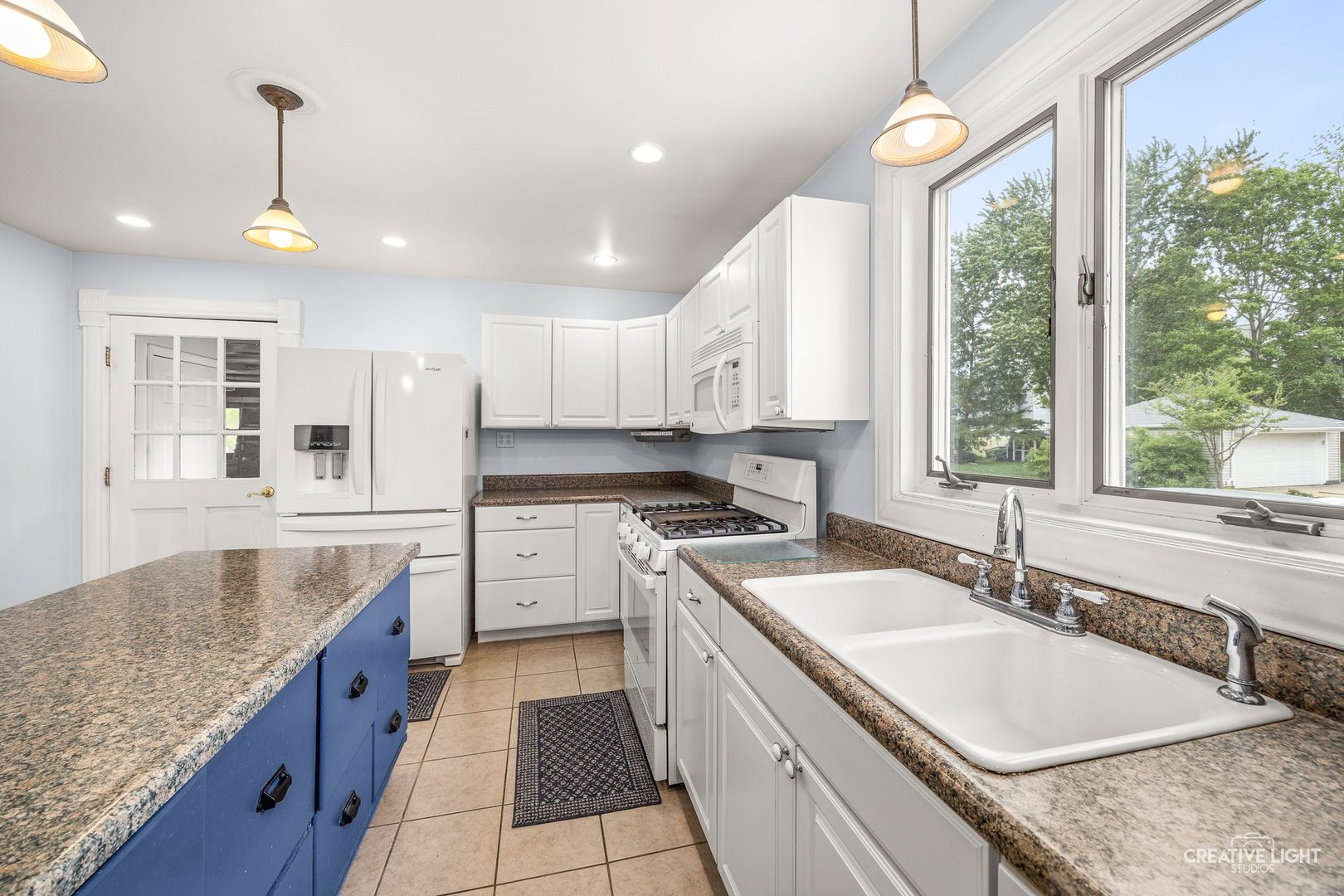 209 North Shabbona Road Shabbona, IL 60550 - Photo 11 of 25 a large kitchen with granite countertop a large center island attached withe living room