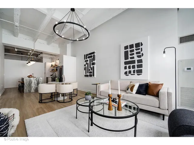a living room with furniture a rug and a window