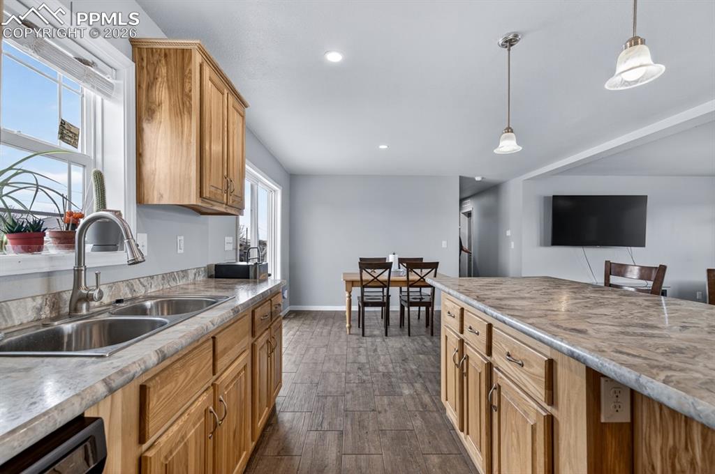 736 Indiana Avenue Limon, CO 80828 - Photo 12 of 37 a kitchen with stainless steel appliances granite countertop a sink a stove and a wooden cabinets