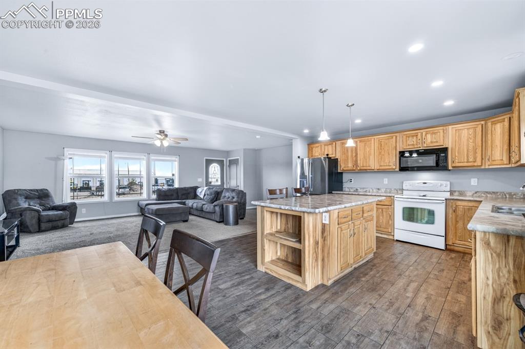 736 Indiana Avenue Limon, CO 80828 - Photo 15 of 37 a large white kitchen with lots of counter space a sink and appliances
