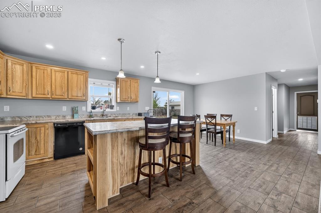 736 Indiana Avenue Limon, CO 80828 - Photo 17 of 37 a kitchen with lots of counter top space and dining table