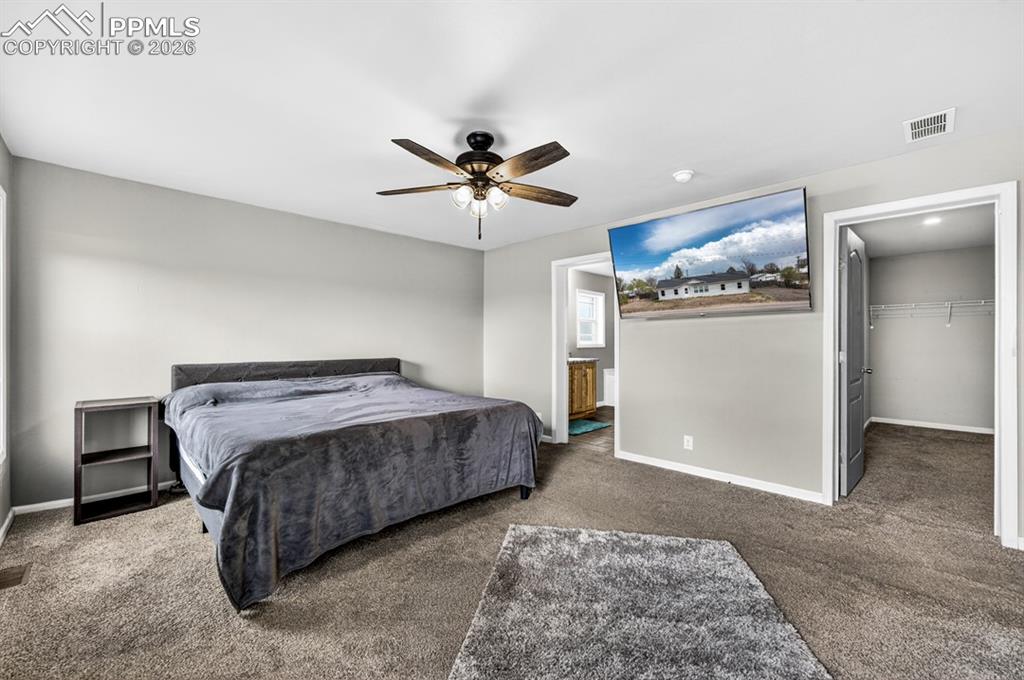 736 Indiana Avenue Limon, CO 80828 - Photo 20 of 37 a spacious bedroom with a bed and a ceiling fan