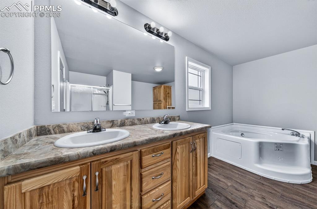 736 Indiana Avenue Limon, CO 80828 - Photo 22 of 37 a bathroom with a granite countertop double vanity sink and mirror