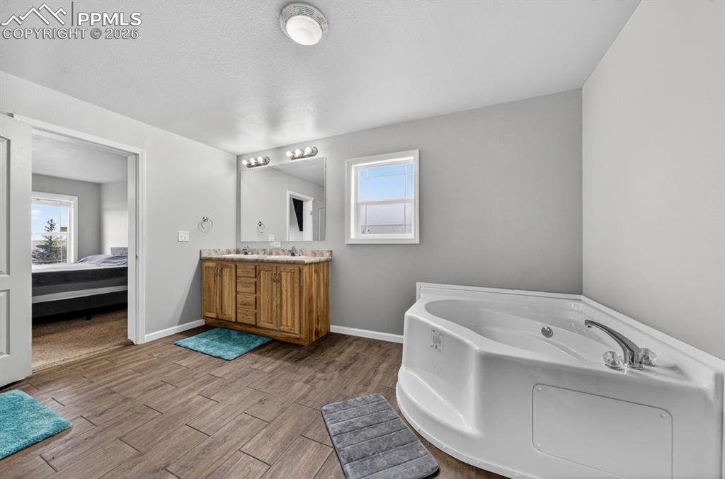 736 Indiana Avenue Limon, CO 80828 - Photo 25 of 37 a bathroom with a tub sink and mirror