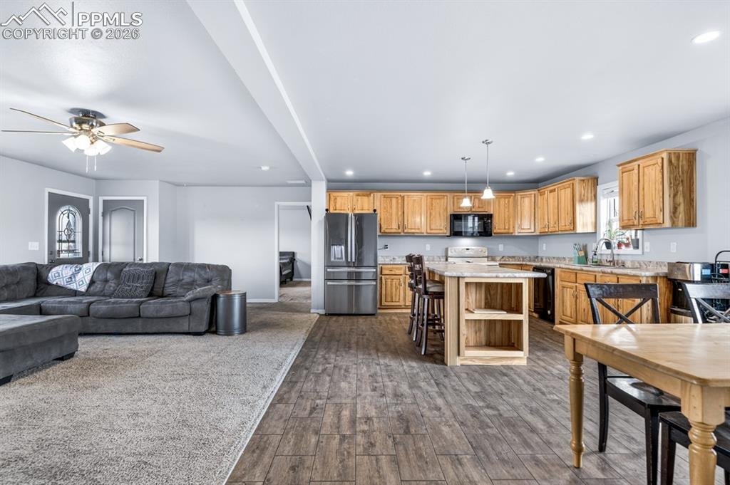 736 Indiana Avenue Limon, CO 80828 - Photo 7 of 37 a living room with stainless steel appliances kitchen island granite countertop furniture and a kitchen view