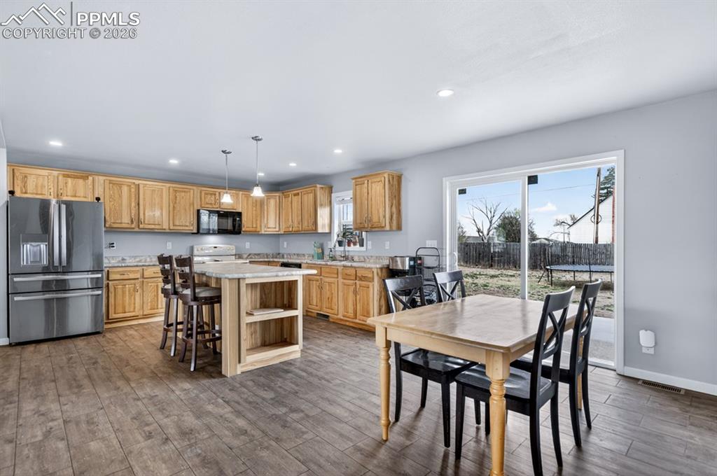 736 Indiana Avenue Limon, CO 80828 - Photo 8 of 37 a kitchen with a table chairs microwave and cabinets