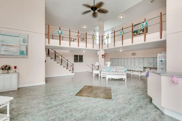 a view of a house with a yard and potted plants