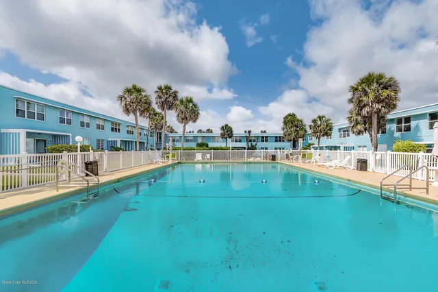 a view of swimming pool with outdoor seating and yard in back