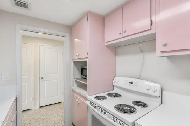 an empty room with floor to ceiling windows and ceiling fan