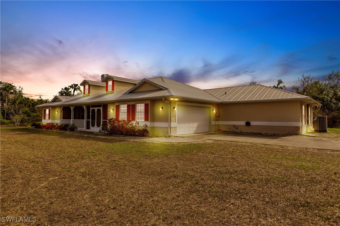 27425 Jones Loop Road Punta Gorda, FL 33982 - Photo 2 of 46 a front view of a house with a garden