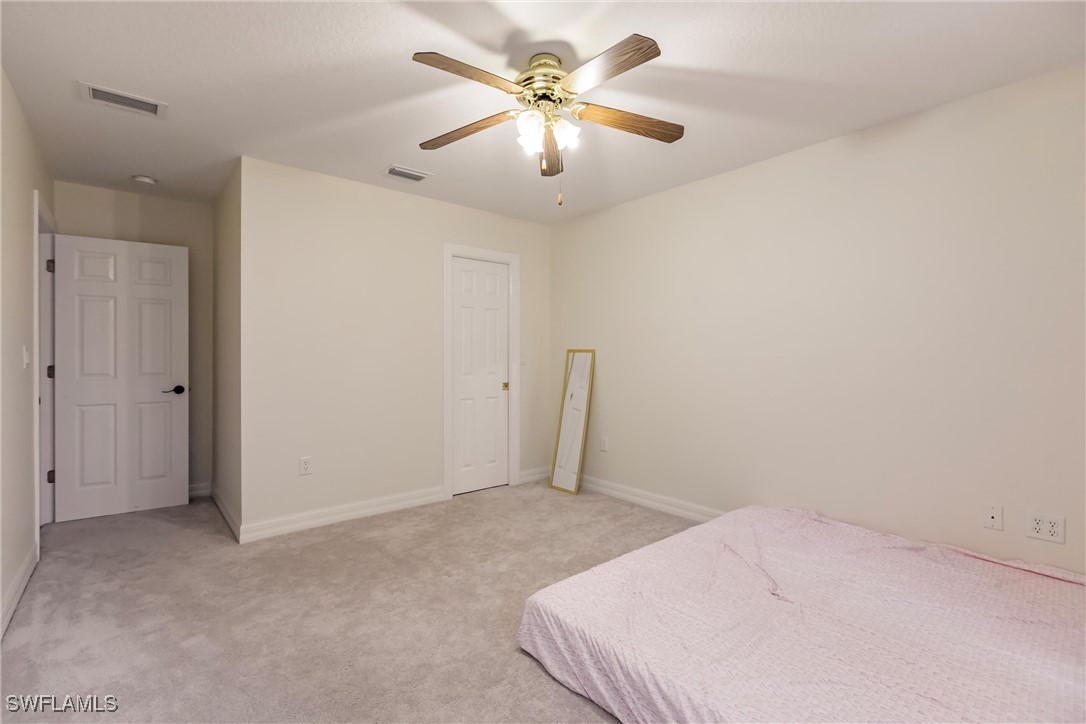 27425 Jones Loop Road Punta Gorda, FL 33982 - Photo 34 of 46 a bedroom with a fan and a fan