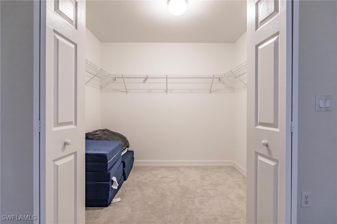 27425 Jones Loop Road Punta Gorda, FL 33982 - Photo 37 of 46 a view of storage and utility room with racks on the wall