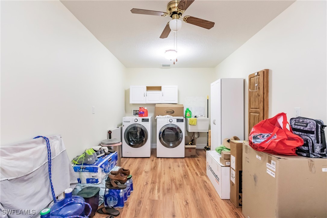 27425 Jones Loop Road Punta Gorda, FL 33982 - Photo 42 of 46 a utility room with dryer washer and a view of living room