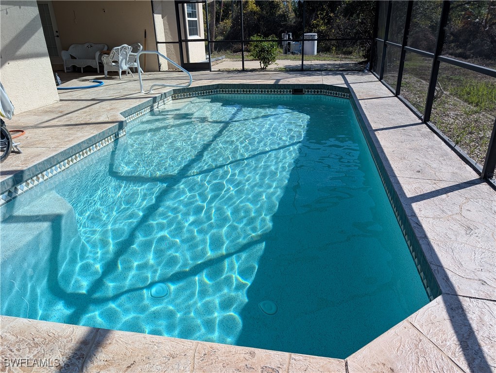 27425 Jones Loop Road Punta Gorda, FL 33982 - Photo 46 of 46 a swimming pool with chairs