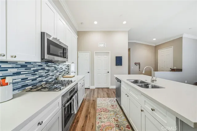 a kitchen with stainless steel appliances granite countertop a stove and a sink