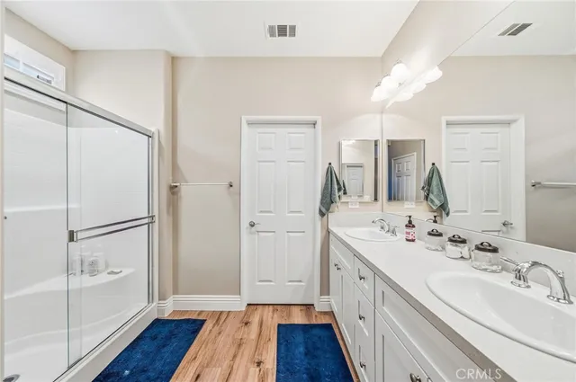 a bathroom with a double vanity sink and mirror