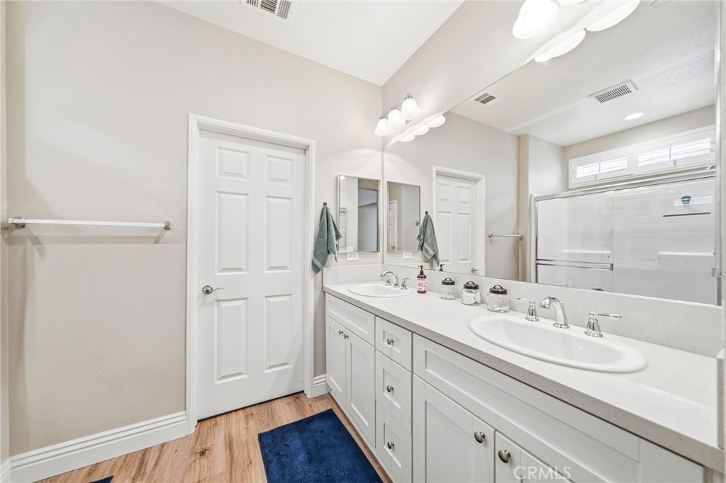26535 Rim Creek Path Menifee, CA 92584 - Photo 25 of 50 a bathroom with a double vanity sink mirror and