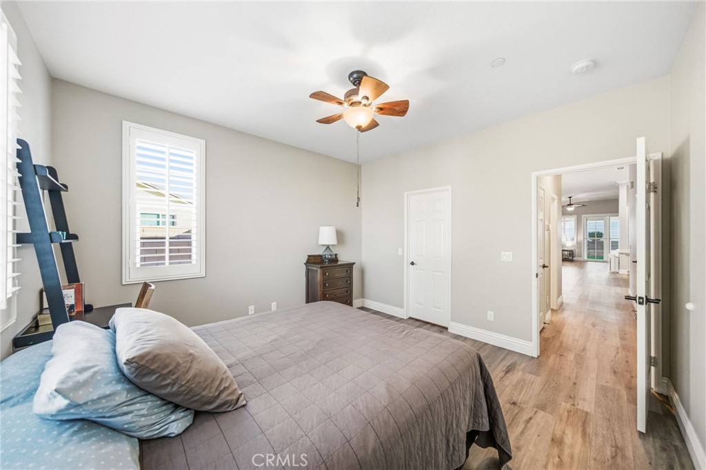 26535 Rim Creek Path Menifee, CA 92584 - Photo 34 of 50 a bedroom with a bed and a chandelier