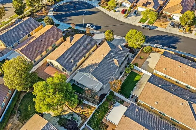 an aerial view of a house with a yard and garden