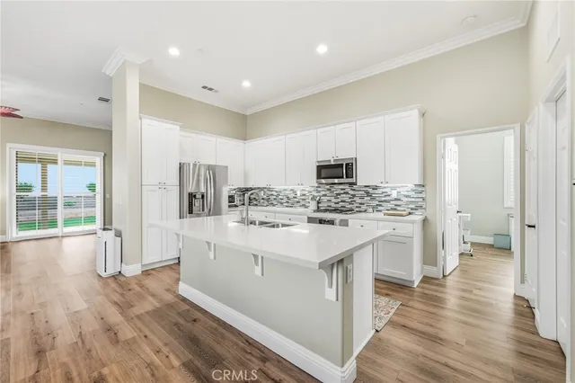 a kitchen with white cabinets and white appliances
