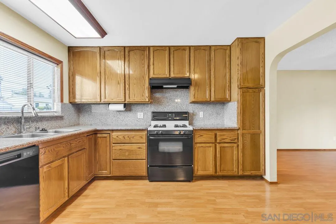 9540 Abbeyfield Road Santee, CA 92071 - Photo 11 of 35 a kitchen with stainless steel appliances granite countertop a stove a sink and a refrigerator
