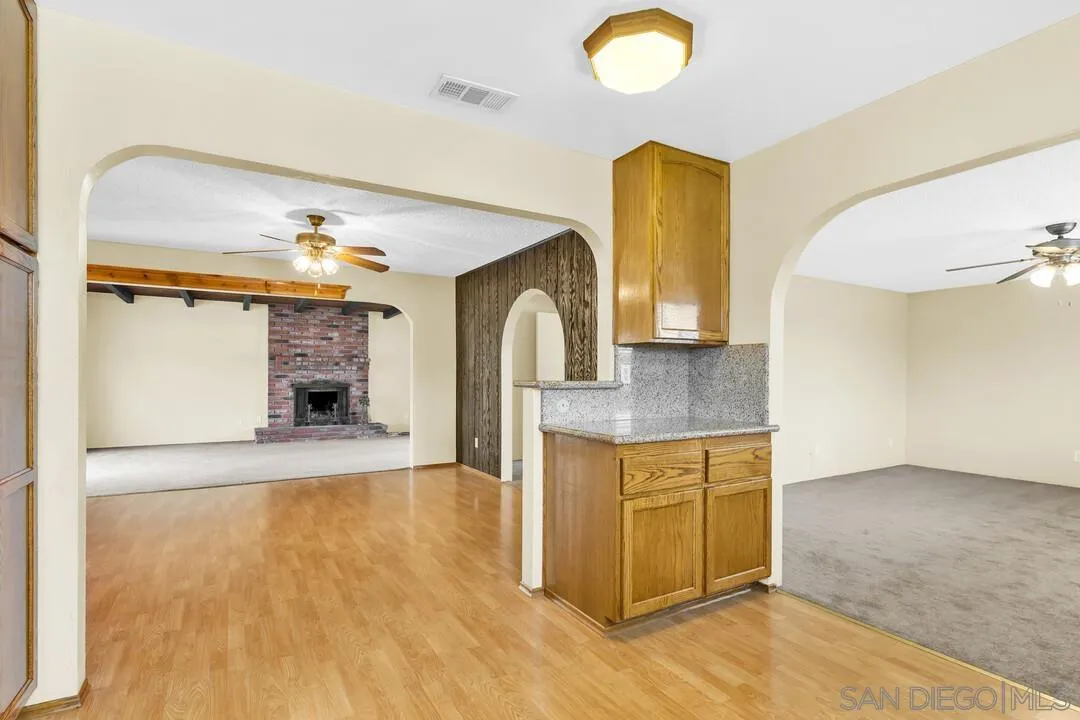 9540 Abbeyfield Road Santee, CA 92071 - Photo 12 of 35 a view of living room with granite countertop furniture and a fireplace
