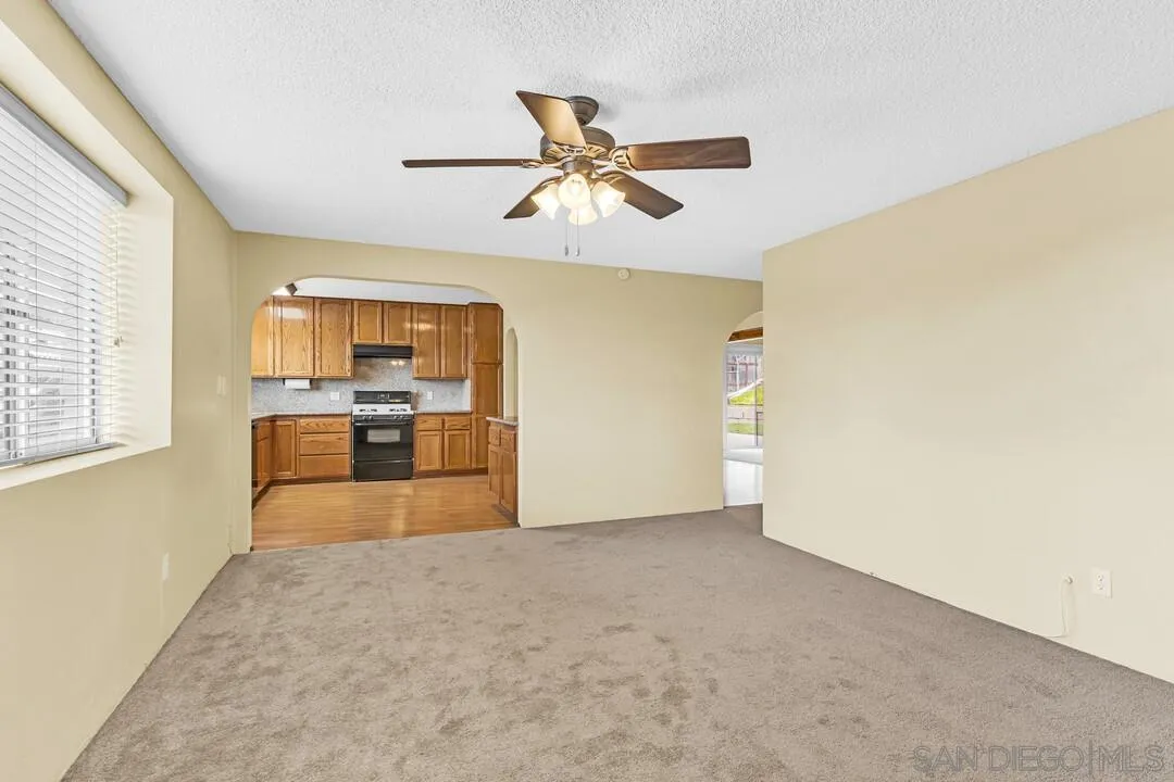 9540 Abbeyfield Road Santee, CA 92071 - Photo 13 of 35 a view of a kitchen with a sink and dishwasher cabinet with a flat screen tv