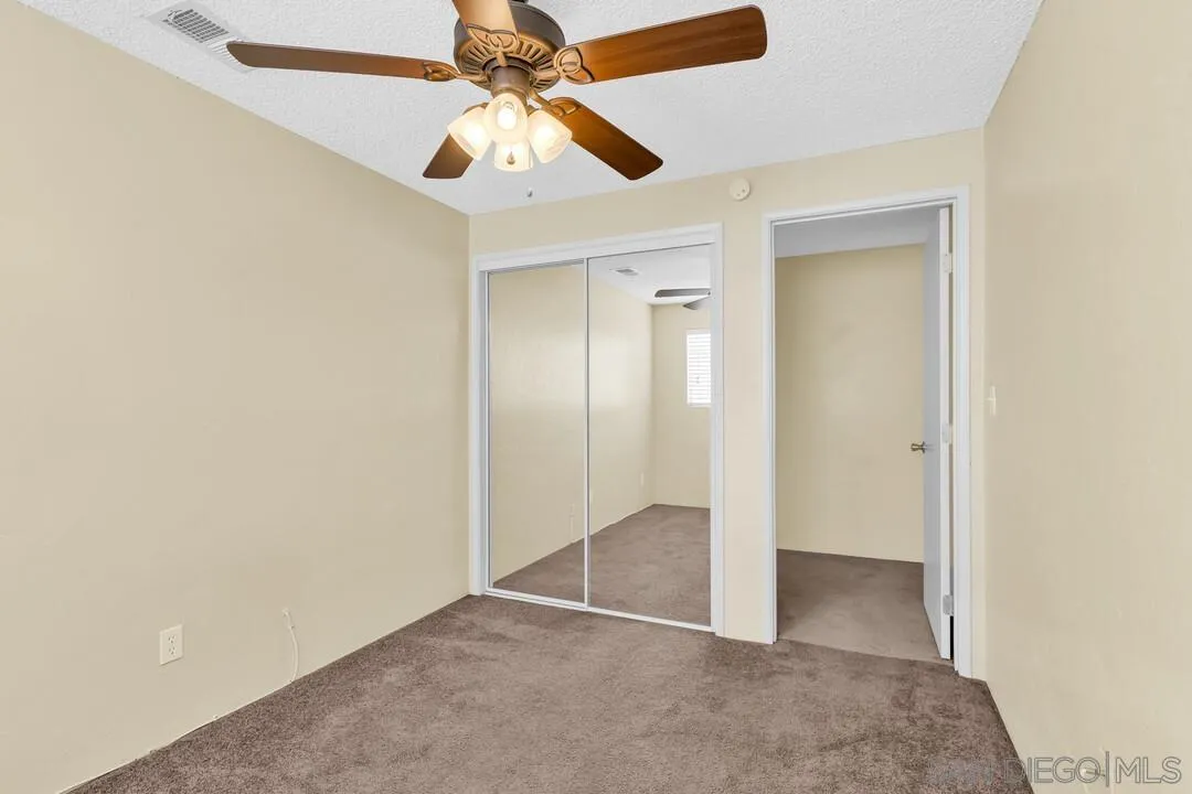 9540 Abbeyfield Road Santee, CA 92071 - Photo 15 of 35 an empty room with closet and a chandelier fan