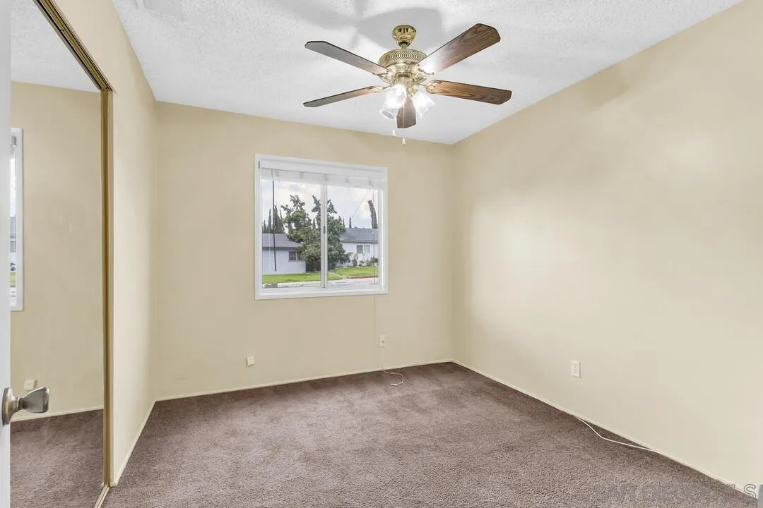 9540 Abbeyfield Road Santee, CA 92071 - Photo 16 of 35 an empty room with a window and a fan