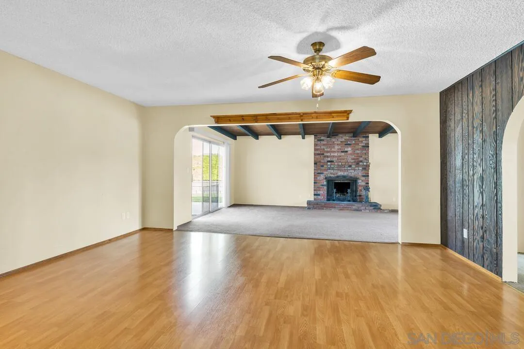 9540 Abbeyfield Road Santee, CA 92071 - Photo 4 of 35 a view of empty room with wooden floor and fan